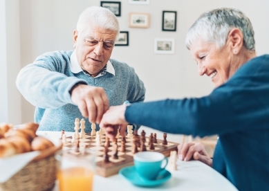 Senior Couple Playing Chess at Kitchen Table